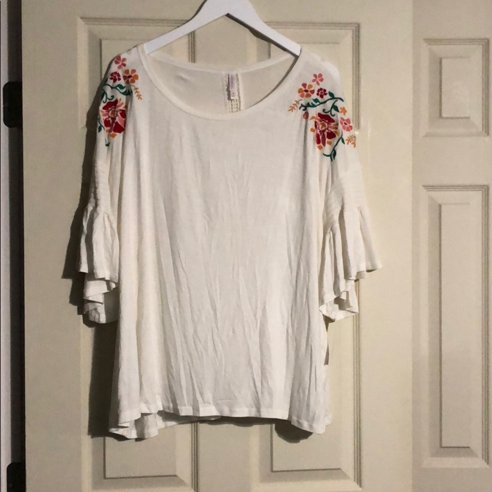 White top with floral design.
